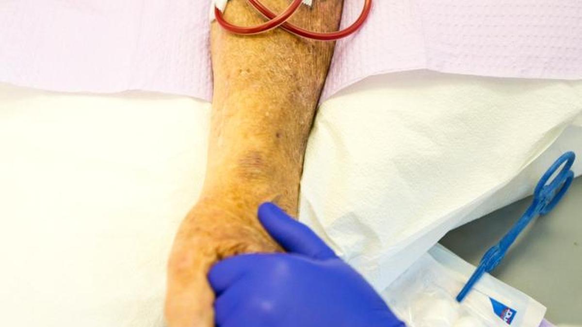 A clinical hemodialysis technician holds a patient’s hand at Meridian Liberty Dialysis. A health care job and career fair will be held Tuesday, Feb. 23, at Carrington College in Boise.