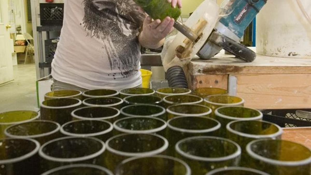 As of 2011, when this photo was taken, the organization now known as Usful Glassworks kept 30,000 wine, beer and liquor bottles out of the landfill and turned them into other items. Jennifer Logan polished the inside rim of drinking glasses made from used wine bottles.