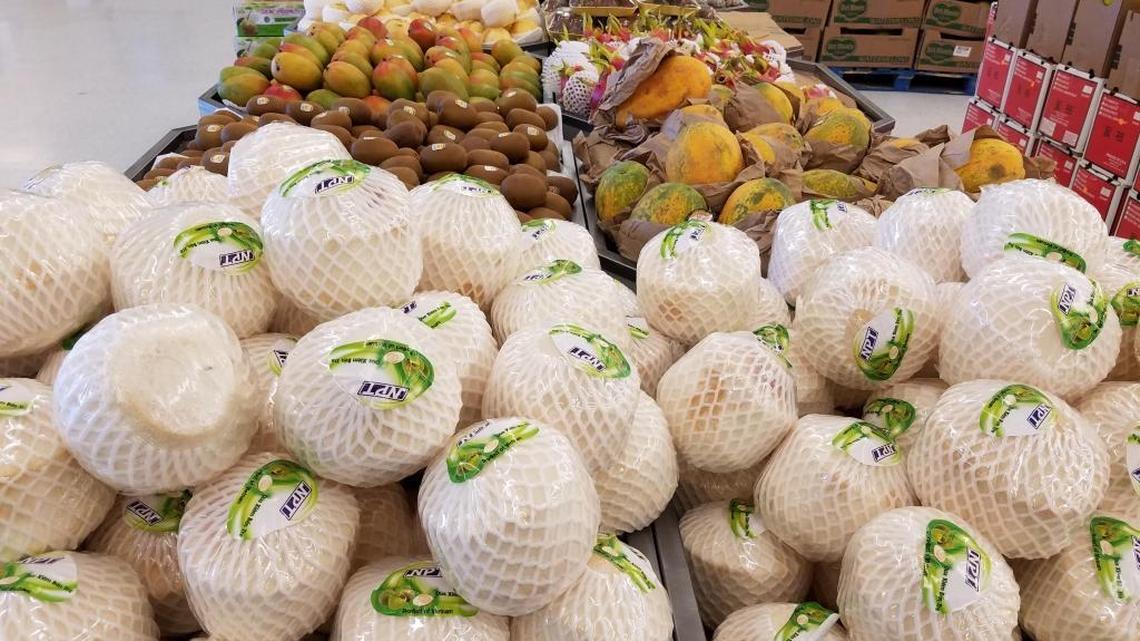 Coconuts, kiwi, mangoes and other fruits line display counters at the Trade Viet store in Boise.