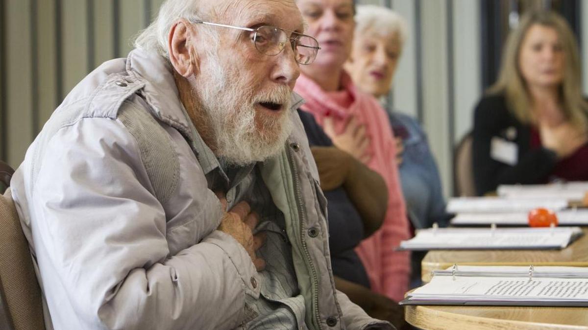 Lee, at the Samaritan Village on Collister Drive in Boise, salutes the flag as the Songtime Singers sing “The Star-Spangled Banner.” Samaritan Village is one of the care facilities where residents receive gifts from the Soroptimits International of Boise.