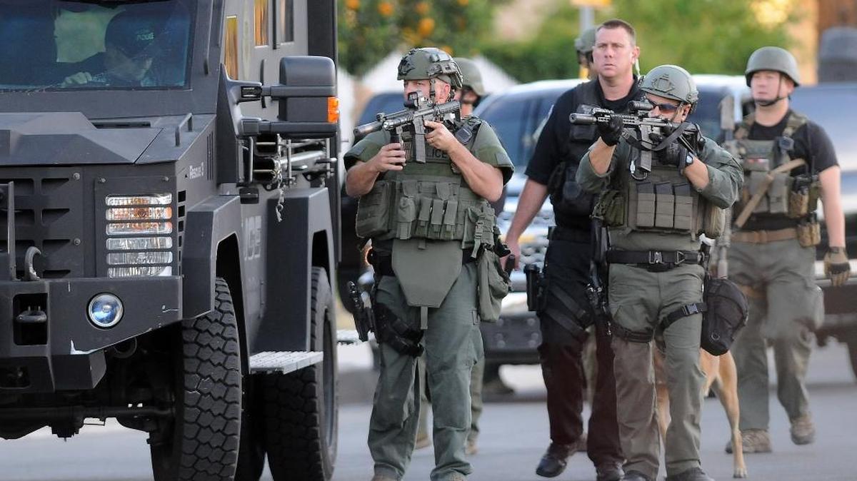 Authorities search an area Wednesday following a shooting that killed multiple people at a social services center for the disabled in San Bernardino, Calif.