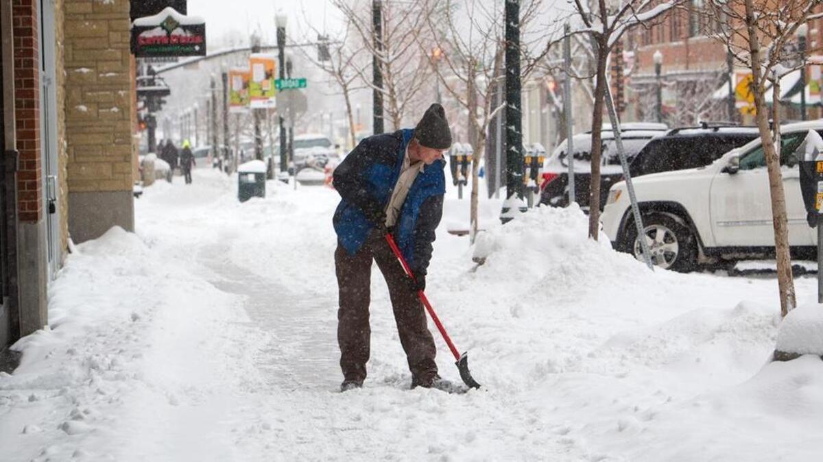 Larry Heckel, with Colliers property management, helps clear sidewalks in BoDo. The Idaho Attorney General’s office and Ada County Highway District disagree on whether the district or private property owners are responsible for clearing snow from sidewalks.