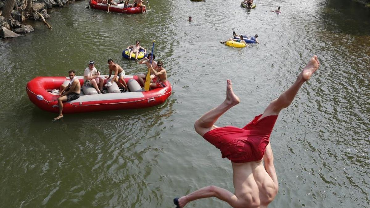 The pedestrian bridge that connects Warm Springs Golf Course to ParkCenter Blvd. was a popular spot for jumpers on Monday afternoon, the final day of operations at Barber Park for float season on the Boise River.