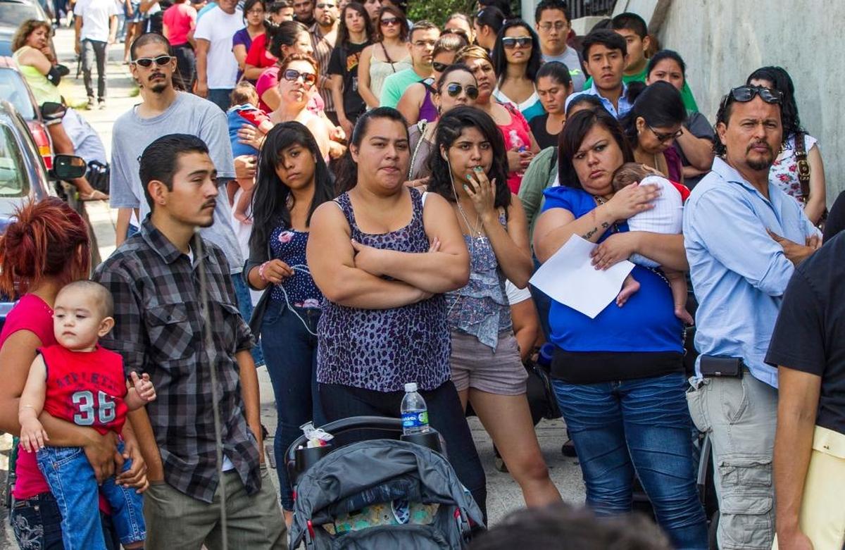 People living in the U.S. without legal permission wait outside the Coalition for Humane Immigrant Rights in Los Angeles in 2012. California is suing the Trump administration over its decision to add a question about citizenship to the 2020 U.S. Census. California and other big states with large immigrant populations could lose congressional seats if noncitizens avoid the census because they are scared to answer the question.
