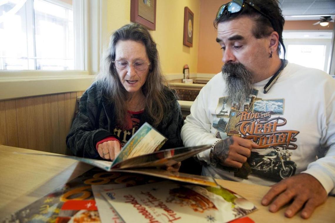 Nena Harrell helps her husband Jamie Harrell choose a spinach and mushroom omelet from a restaurant menu. He is legally blind, but can see some detail up close.