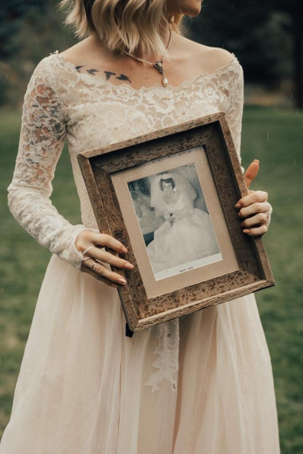 Jordyn Cleverly holds the 1962 photo of her grandmother Penny Jensen wearing the same wedding dress in 1962. Cleverly never knew her grandfather. Penny’s husband died before Cleverly was born.