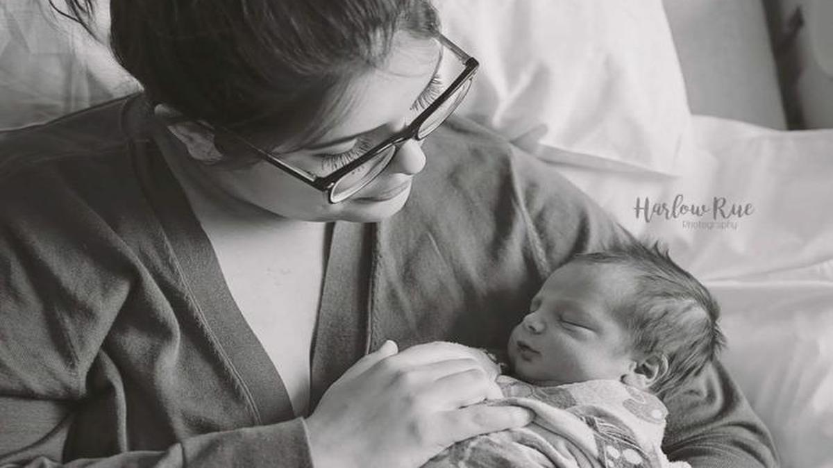 Alyssa Ruiz poses for a photograph with her newborn son, Anderson Paul Turner, born at 1:03 a.m. Monday on the side of Interstate 84.