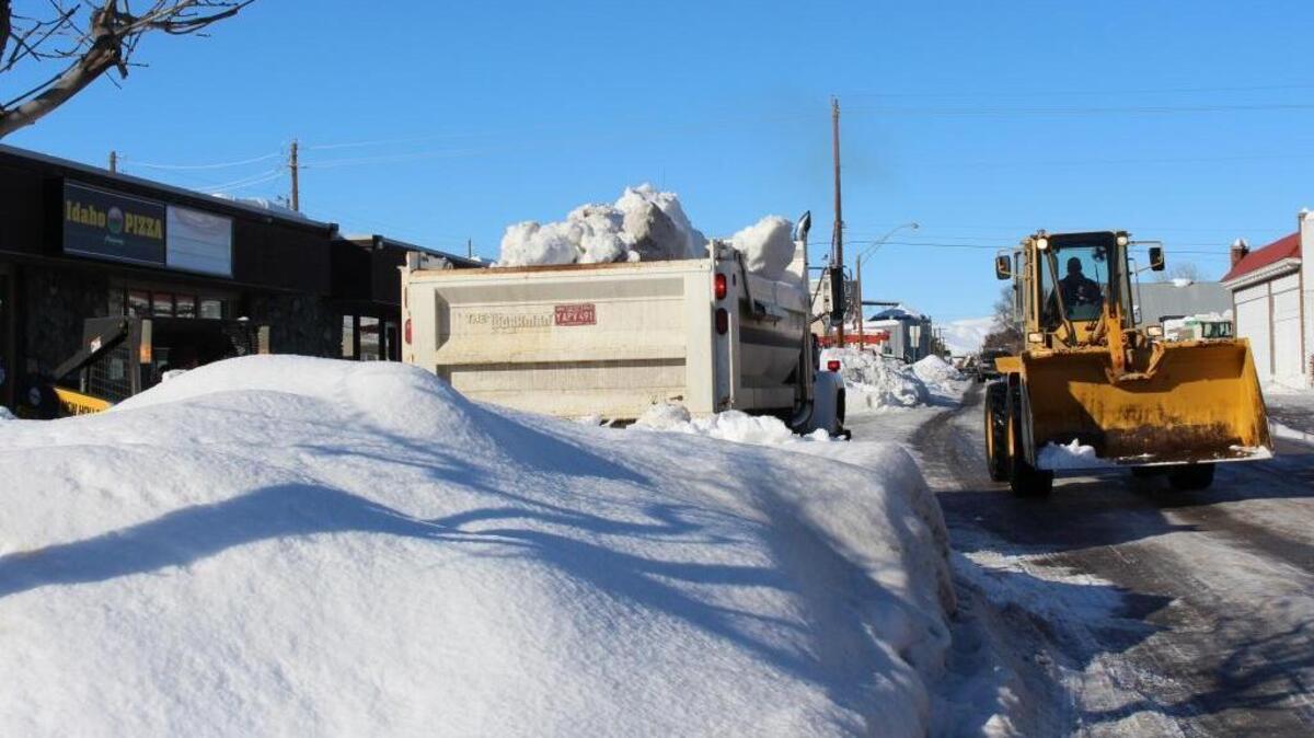 Crews and machinery, hauling snow out of downtown Weiser Tuesday, hope to have the business district streets cleared by Wednesday.