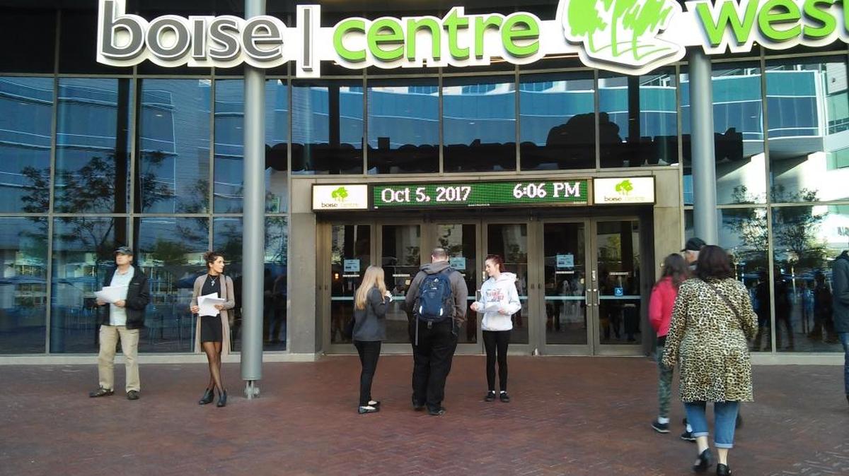 Volunteers for a stadium opposition group pass out flyers to people arriving at the Boise Centre for Thursday’s open house.