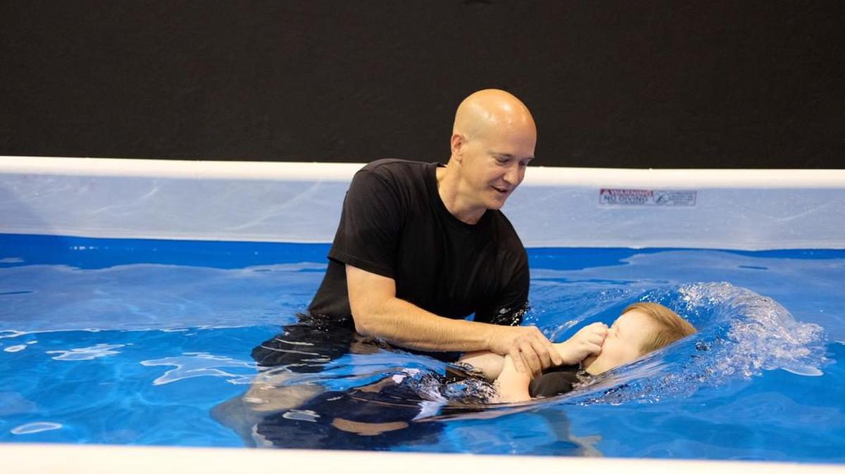 Jarrod Clymer baptizes his son, Joshua Clymer, 12, on Saturday at the annual Jehovah’s Witnesses Regional Convention at the Ford Idaho Center in Nampa.
