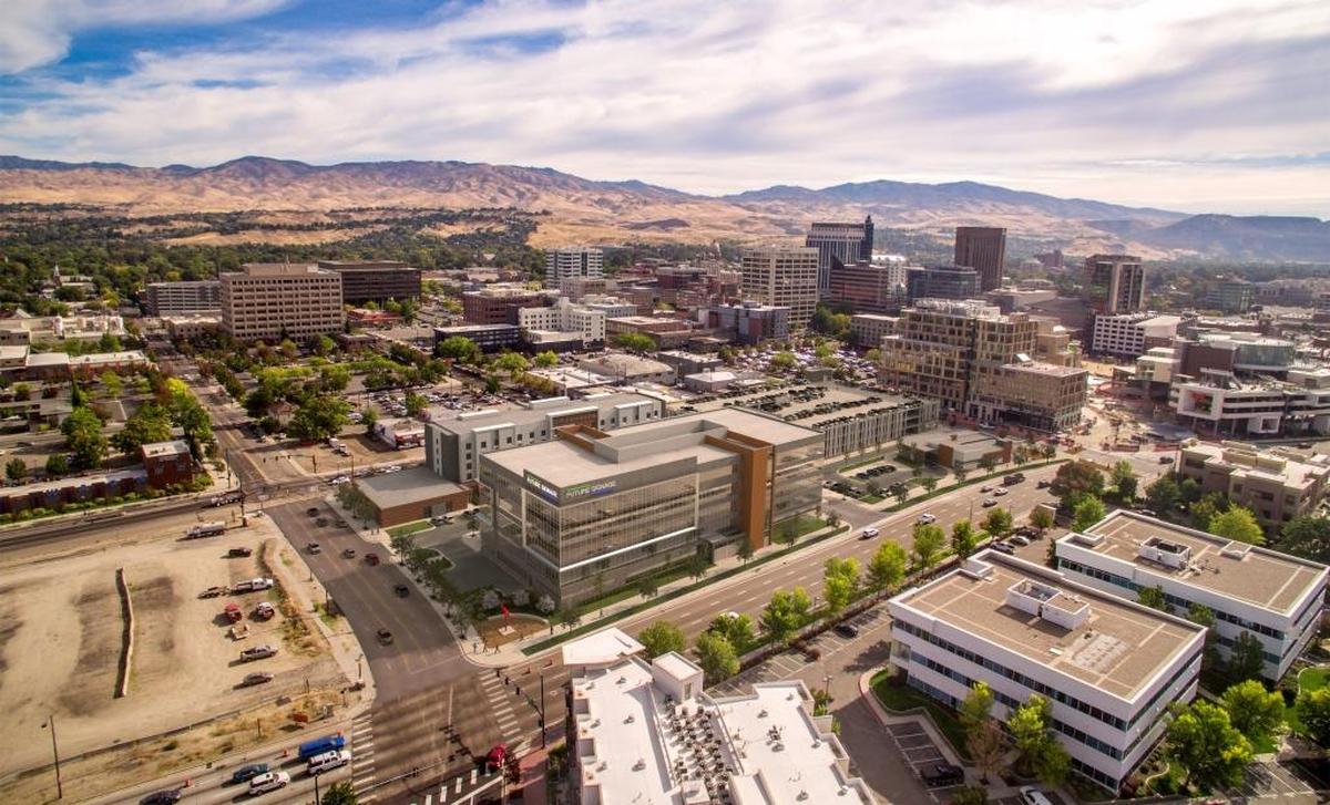 This artist's rendering shows what Gardner Co.'s Pioneer Crossing project, between Front and Myrtle streets on the west side of Downtown, will look like from the southwest. An office building, now under construction, is in the foreground. A nearly completed Hilton Garden Inn hotel is just behind that. An already open parking garage, whose design has drawn criticism, is to the right of these buildings. A soon-to-open Panera Bread restaurant is in front of the garage. The J.R. Simplot Co.’s headquarters and JUMP are to the right of the project.
