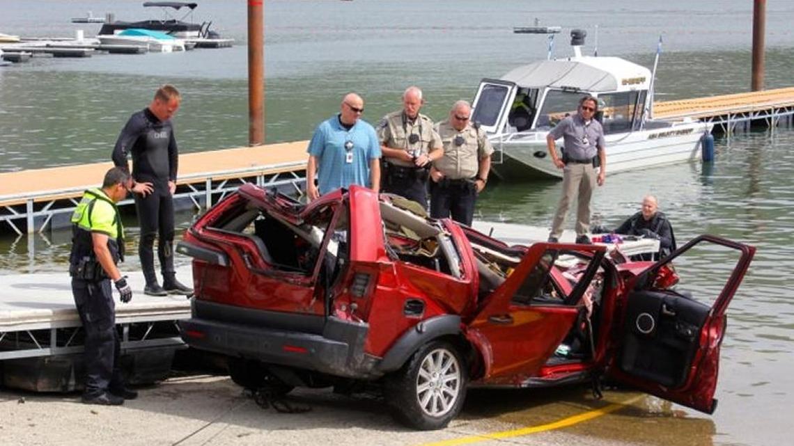 Investigators examine the SUV after it was retrieved from the reservoir in June.