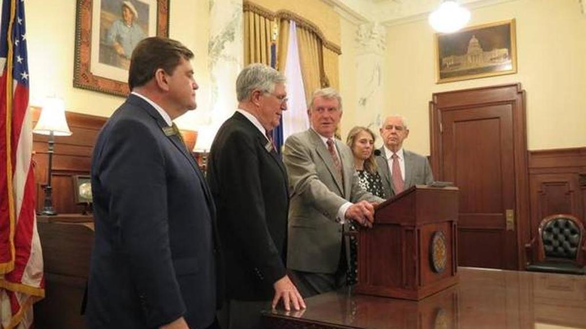 In late March, Gov. Butch Otter, center, at one of the ceremonial bill signings, said a new law with stiffer penalties for those who make school threats was well constructed by the Legislature.