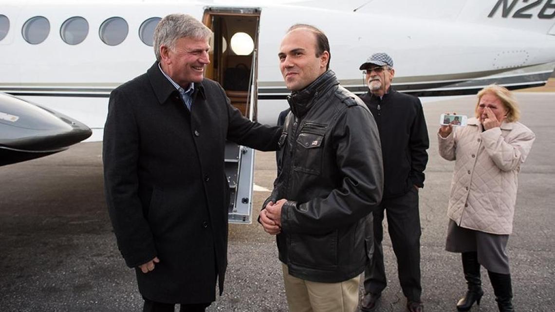 The Rev. Franklin Graham, left, greets Saeed Abedini after Abedini’s return to the United States.