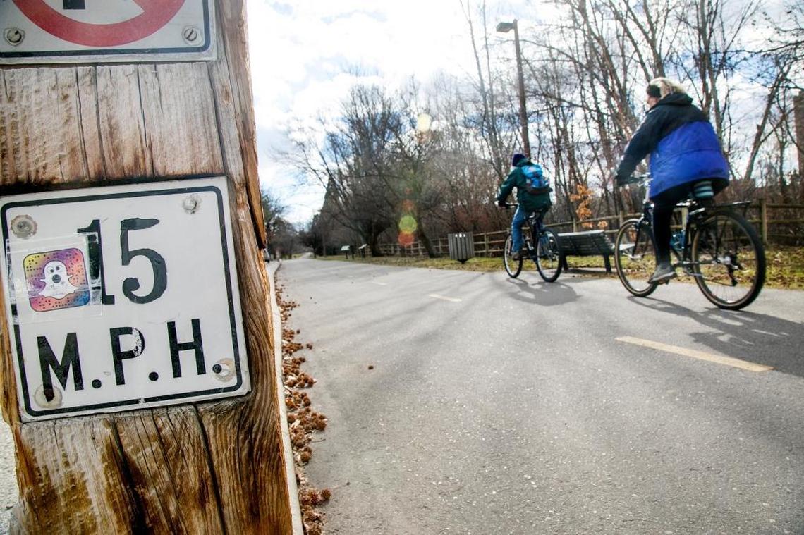 Bicyclists ride past a speed limit sign on the Boise River Greenbelt.