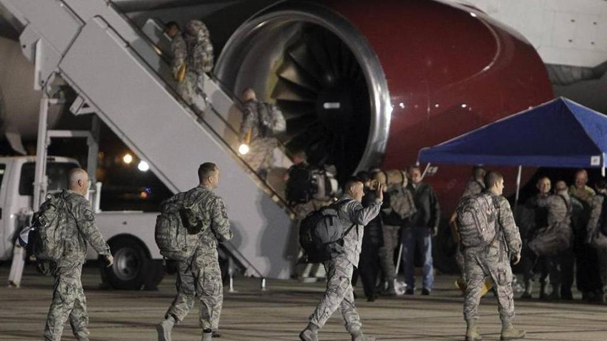 The first wave of 124th Fighter Wing members wave to loved ones as they board a plane at Gowen Field late April 12 at the start of a six-month deployment to the Middle East.