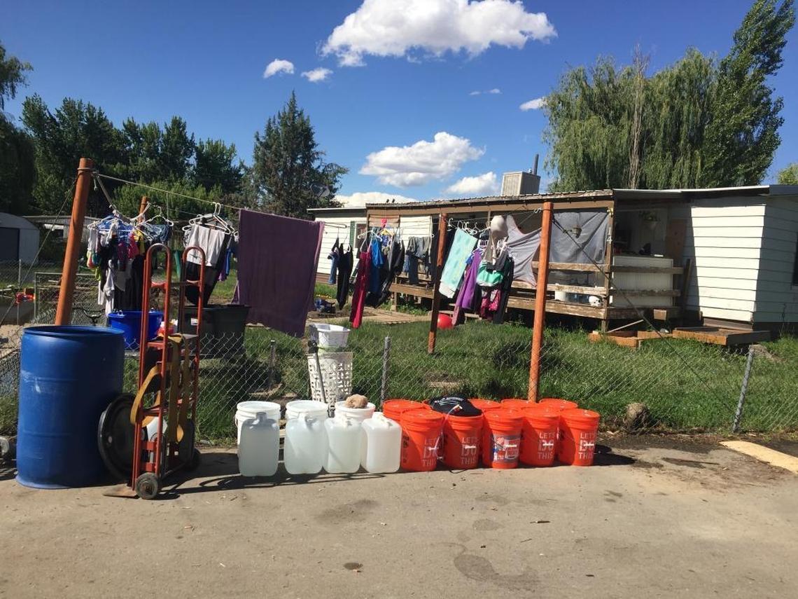 Twenty-eight residents in Riviera Estates Mobile Home Park in Eagle have chosen to stay despite a mandatory evacuation order due to flooding. These clotheslines are used to dry the residents’ clothing while they are without power, and the water jugs have been donated to them by local businesses for use until they regain running water.