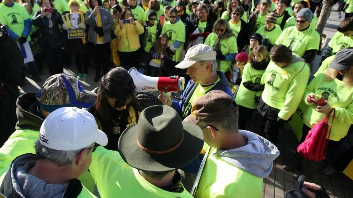 Naghmeh Abedini and supporters of Saeed pray during a rally at Boise State University ahead of a visit from President Barack Obama on Jan. 21, 2015.