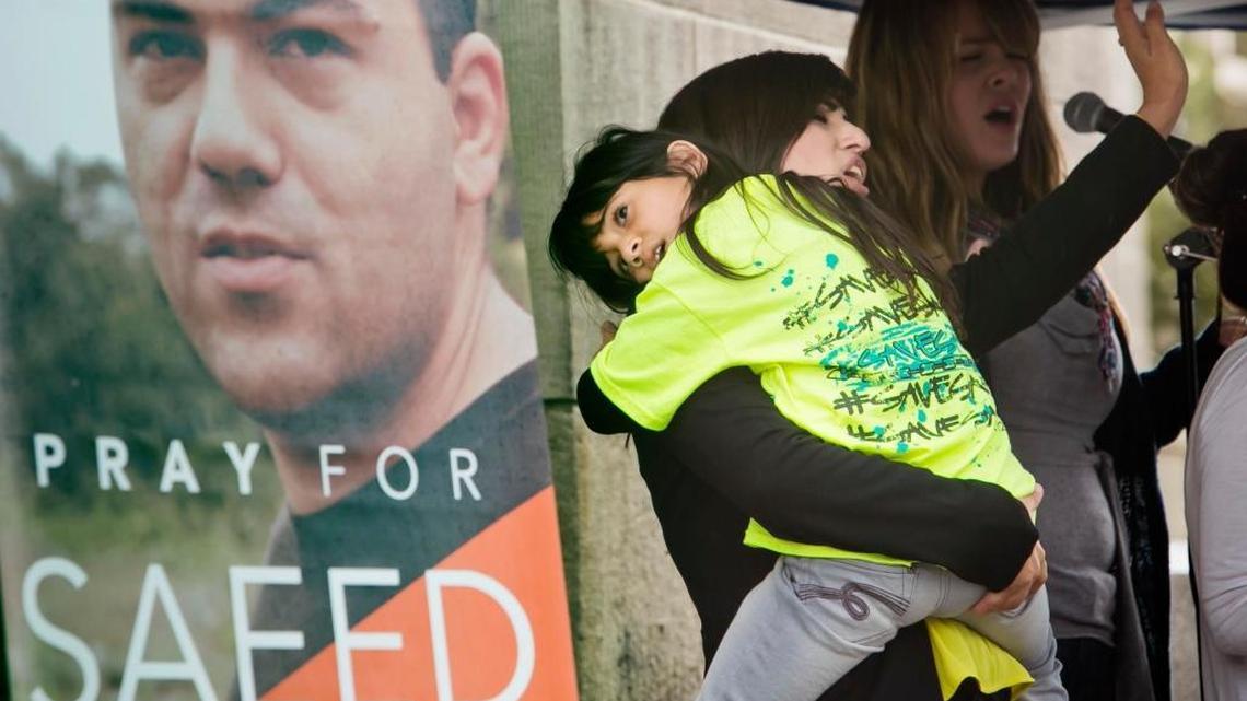 Naghmeh Abedini holds her daugher Rebekka at a 2013 prayer vigil seeking freedom for her husband, Boise pastor Saeed Abedini, who was arrested in Iran.