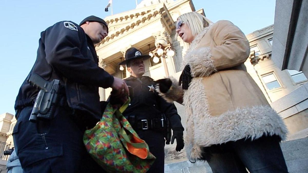 Marijuana supporter Serra Frank, director of the Mom Squad at Moms for Marijuana International, is approached on the steps of the Idaho State Capitol on Jan. 1 after letting police officers know she was in possession of marijuana. Frank had just spoken to a small group of people interested in changing Idaho’s marijuana laws.