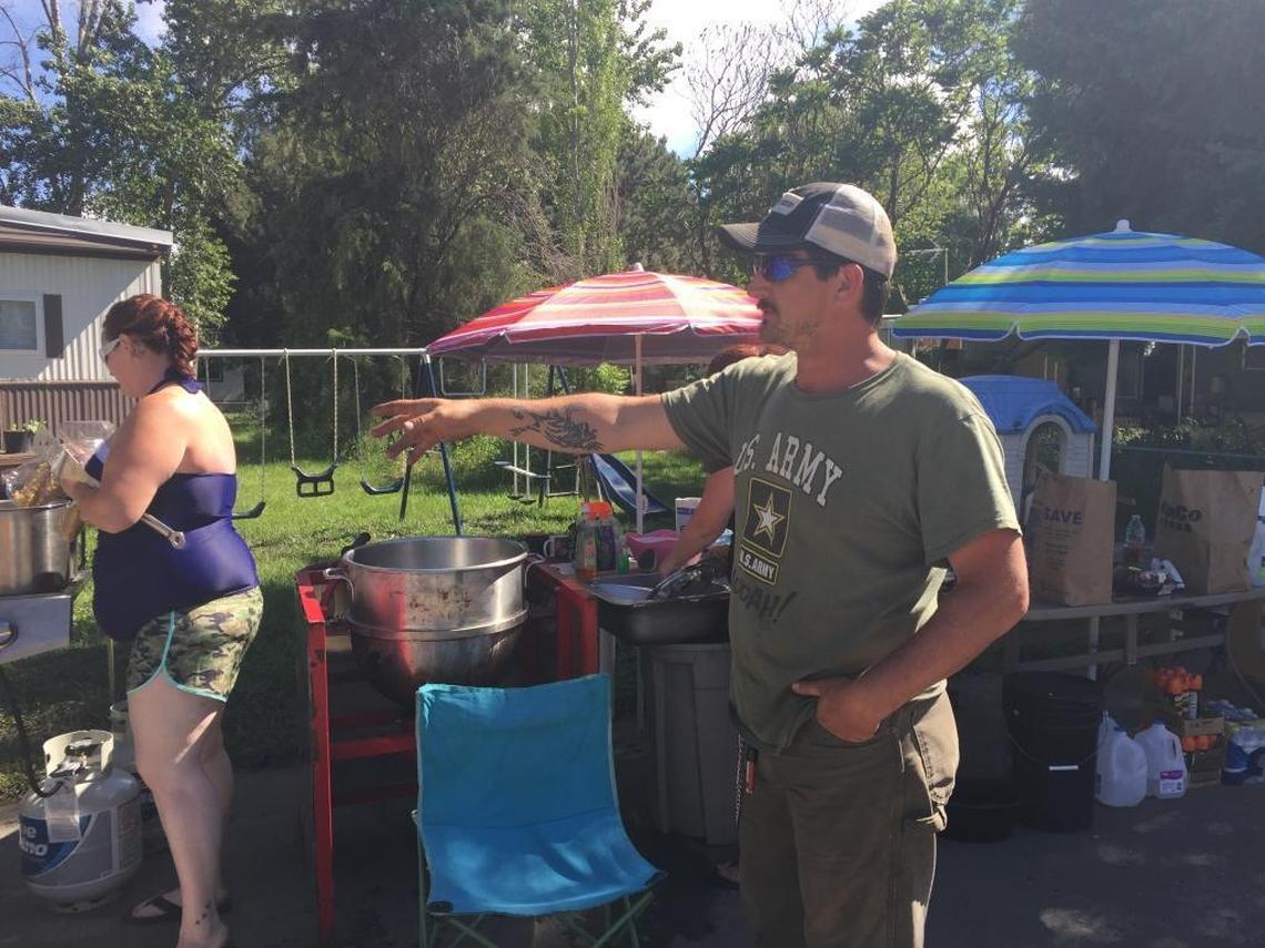 J.R. VanHoover, a resident in Riviera Estates Mobile Home Park, has chosen to stay in the park despite a mandatory evacuation order. Friday, he pointed out his large kettle corn pot that he now allows his neighbors to use for boiling water while the neighborhood is without running water.