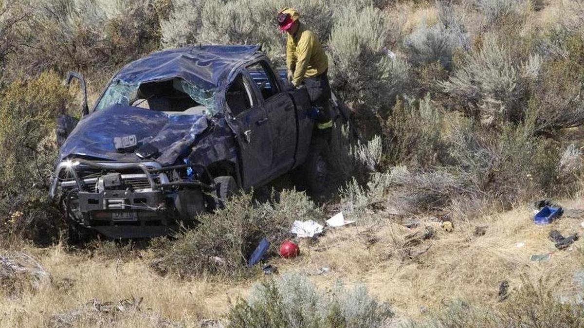 Authorities respond to the scene Thursday where a pickup truck rolled some 200 feet down an embankment after leaving Bogus Basin Road for unknown reasons.