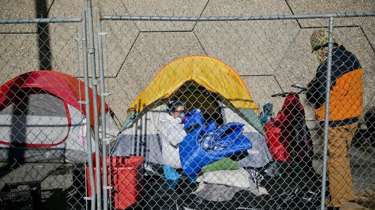 Workers (who declined to give their names) conduct an inventory of empty tents at the now fenced off former homeless encampment called Cooper Court in Boise, Idaho. Saturday December 5, 2015