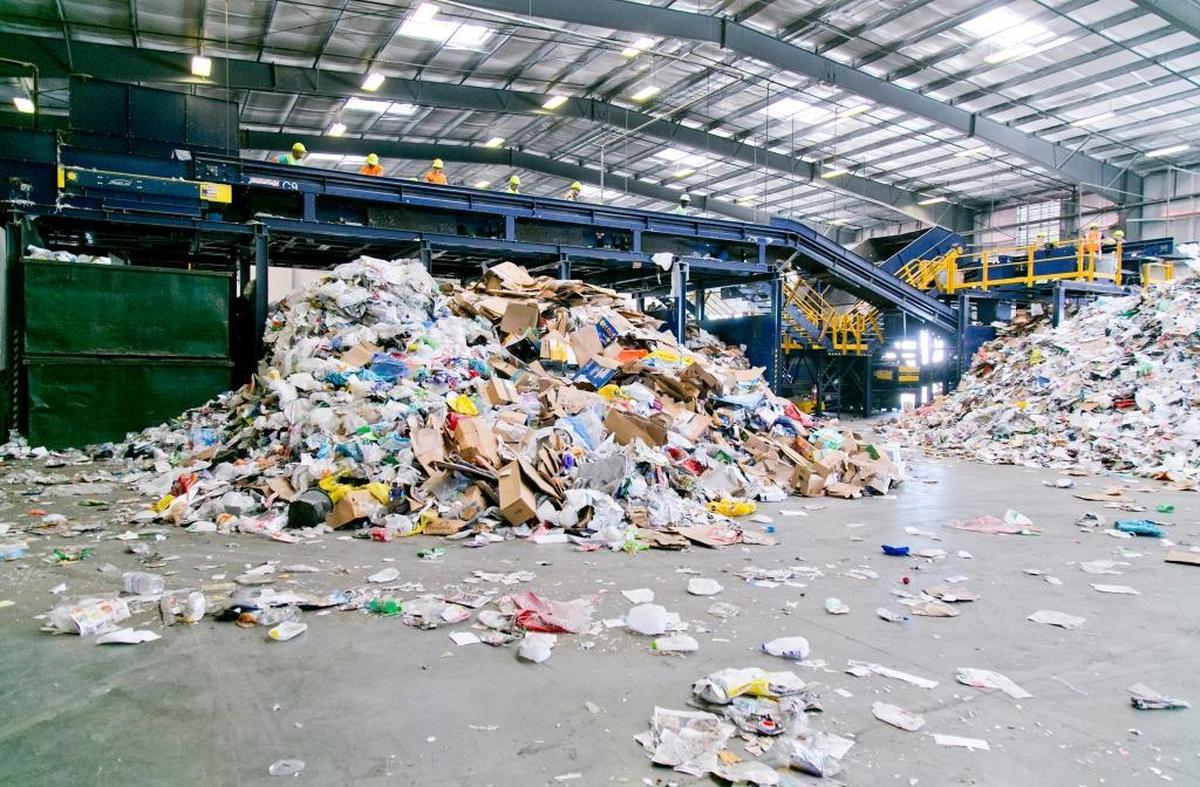 Workers sort through recyclables delivered to a Western Recycling plant in Boise.