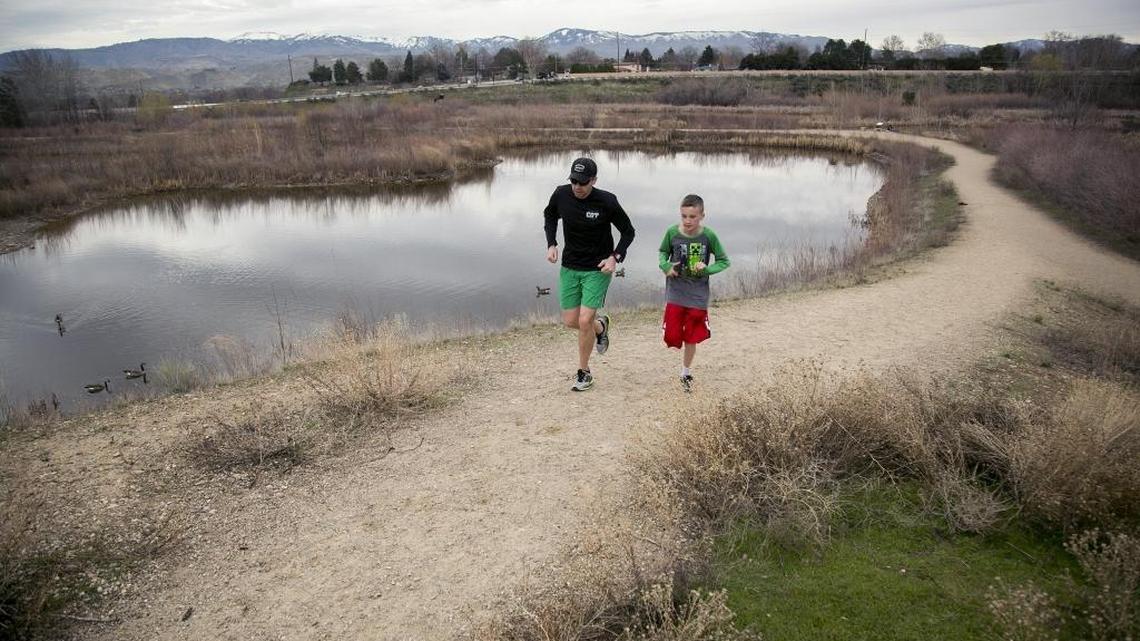 Jason and Luke Hill run at the Hyatt Hidden Lakes Reserve in Boise. A city is charged with reviewing proposals to spend money from a $10 million levy voters passed in 2015 for open space and water quality protection.