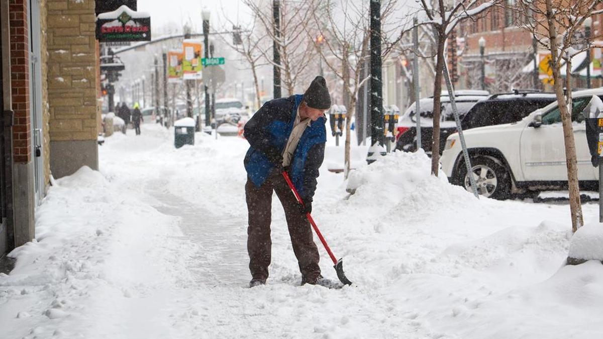 Larry Heckel, with Colliers property management, helps clear sidewalks in BoDo on Jan. 4. A recent opinion from the Idaho Attorney General’s office suggests Ada County Highway District, not private property owners and managers like Colliers, is responsible for clearing snow from sidewalks in the district’s right-of-way.