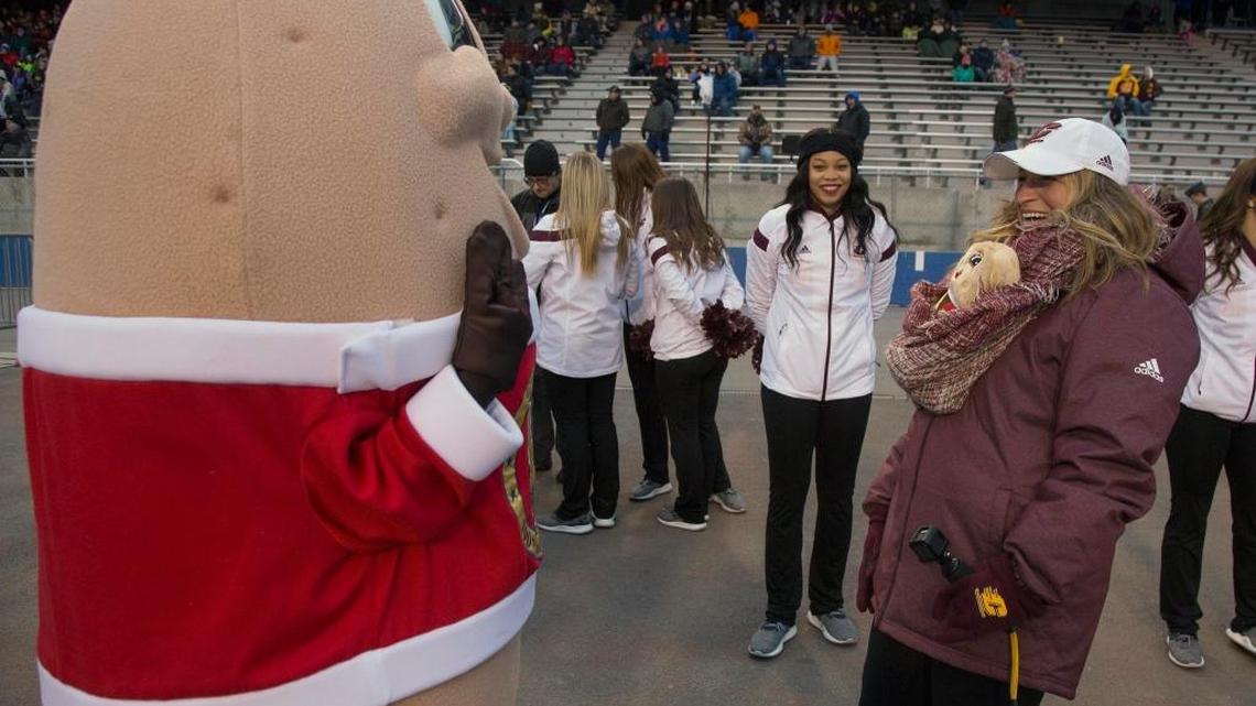 Spuddy Buddy is presented with a surprise by Central Michigan’s cheer team advisor Amy Bunting during the Famous Idaho Potato Bowl Friday, Dec. 22, 2017 at Albertsons Stadium in Boise. “We just love the Spuddy Buddy,” she said.