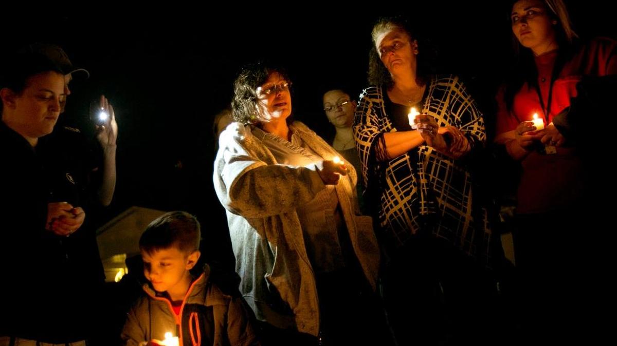 Fran Hopkins of Boise, center, gathers with others who knew and loved her son Michael Casper, who was shot and killed by a Boise police officer Feb. 16, 2015. A candlelight vigil Tuesday evening in front of Casper’s home marked the first anniversary of his death.