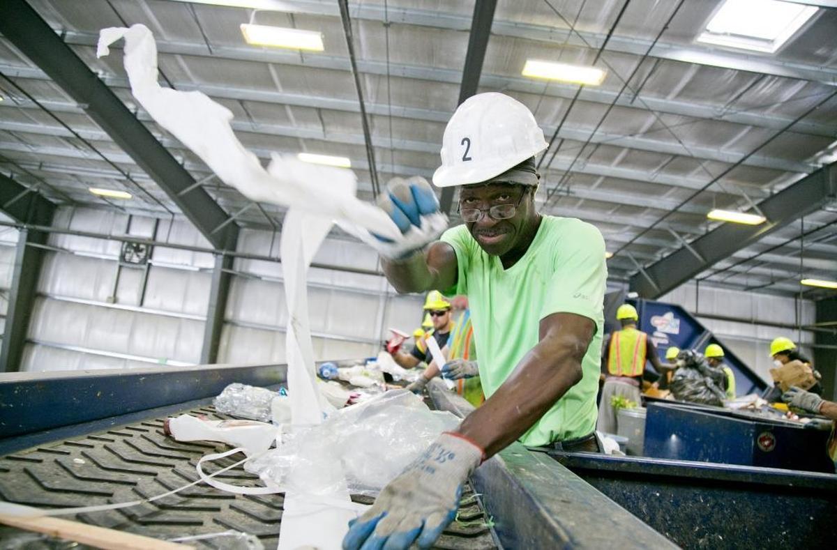 Joe Yamson grabs a piece of plastic coming down a sorting line at a Western Recycling plant in Boise. China’s ban on paper and low-grade plastics has sent cities across the West scrambling for solutions.