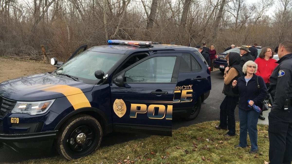 Garden City Councilwoman Elfreda Higgins, center right, checks out a city police vehicle, which bears the new blue and gold colors and badge logo.