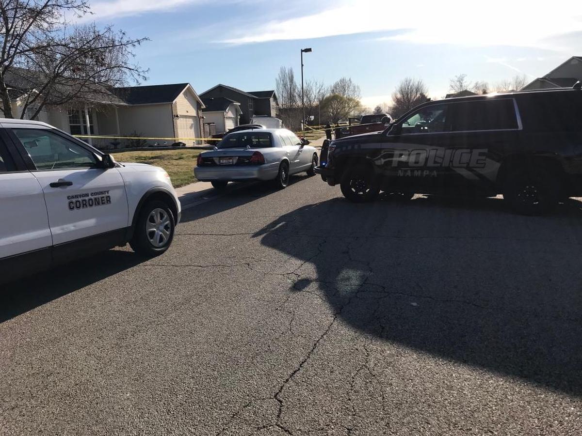 Law enforcement blocks off the road about a block away from the 7500 block of Edgebrook Drive, where Nampa Police Department vehicles and the Canyon County Coroner’s SUV are parked.