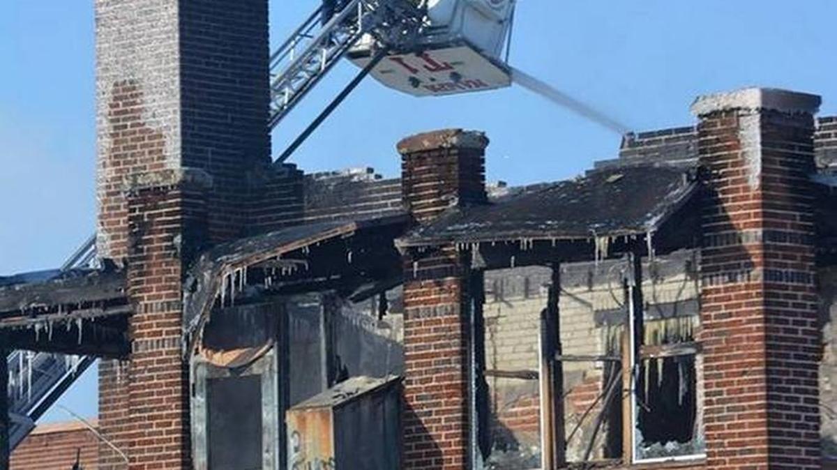 Firefighters on a ladder truck view the damage Jan. 2 after extinguishing a three-alarm fire at Nampa’s old Mercy hospital.
