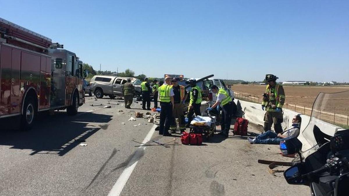 Emergency crews work at the scene of a bizarre crash on westbound Interstate 84 Tuesday afternoon in which a vehicle slammed into a vehicle that had been pulled over, injuring both drivers.