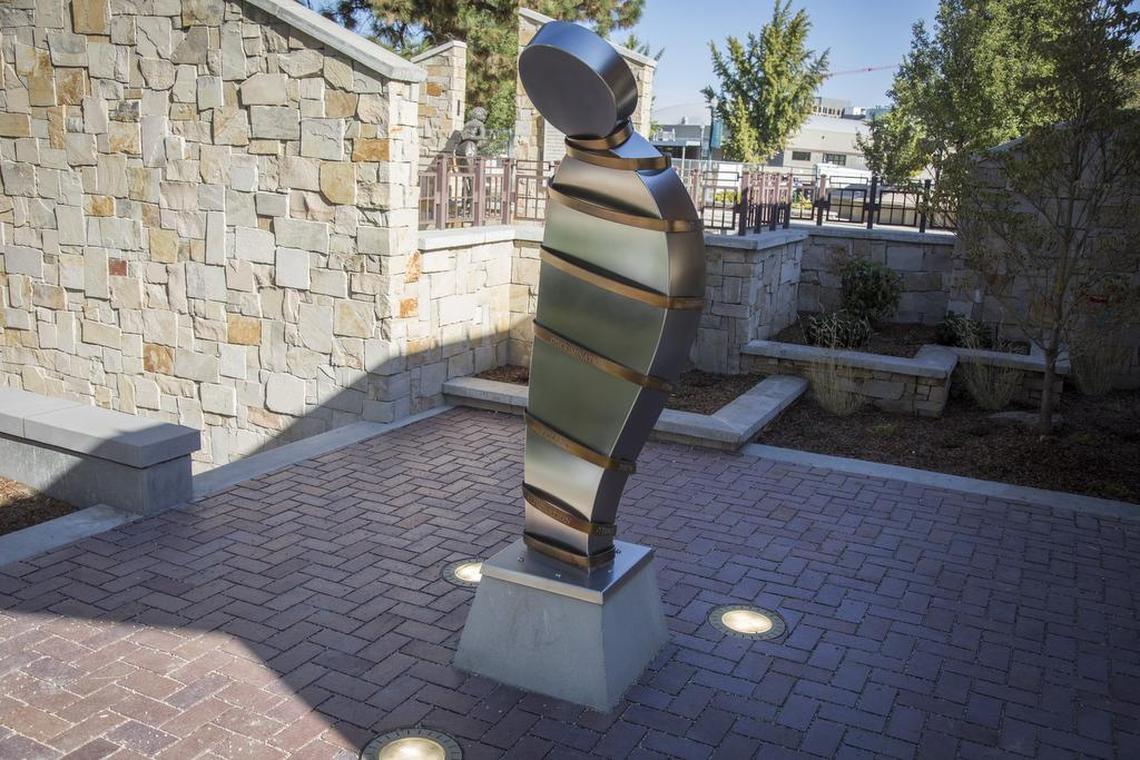 The words language, avoidance, discrimination, violence and elimination describe “The Spiral of Injustice,” designed and fabricated by Ken McCall. The words are in six languages around the figure.