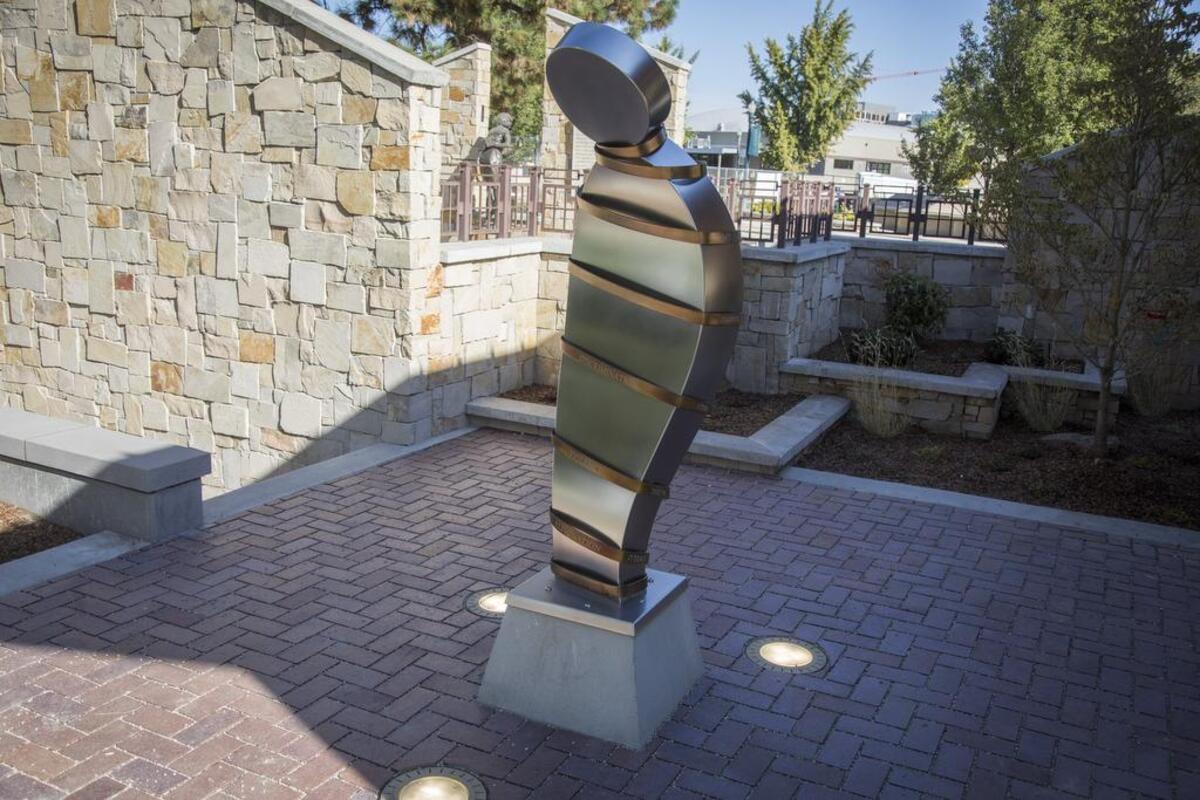 The words language, avoidance, discrimination, violence and elimination describe “The Spiral of Injustice,” designed and fabricated by Ken McCall. The words are in six languages around the figure.