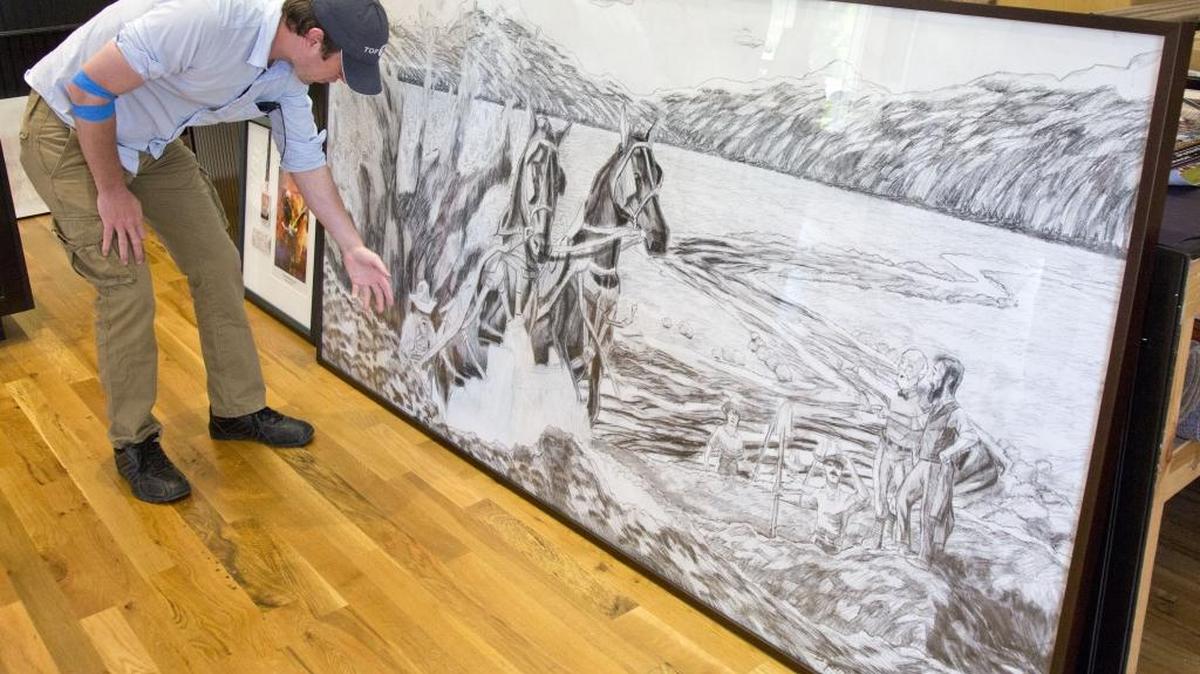 Byron Schexnayder’s artwork is being displayed in a series of large-scale sketches at Eagle City Hall. The scenes depict historic events that have defined the city.