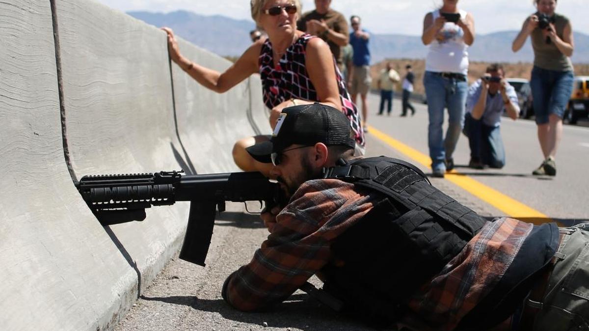 Protester Eric Parker of Hailey aims his weapon from a bridge next to the Bureau of Land Management’s base camp, where seized cattle that belonged to rancher Cliven Bundy were being held in April 2014 near Bunkerville, Nev.