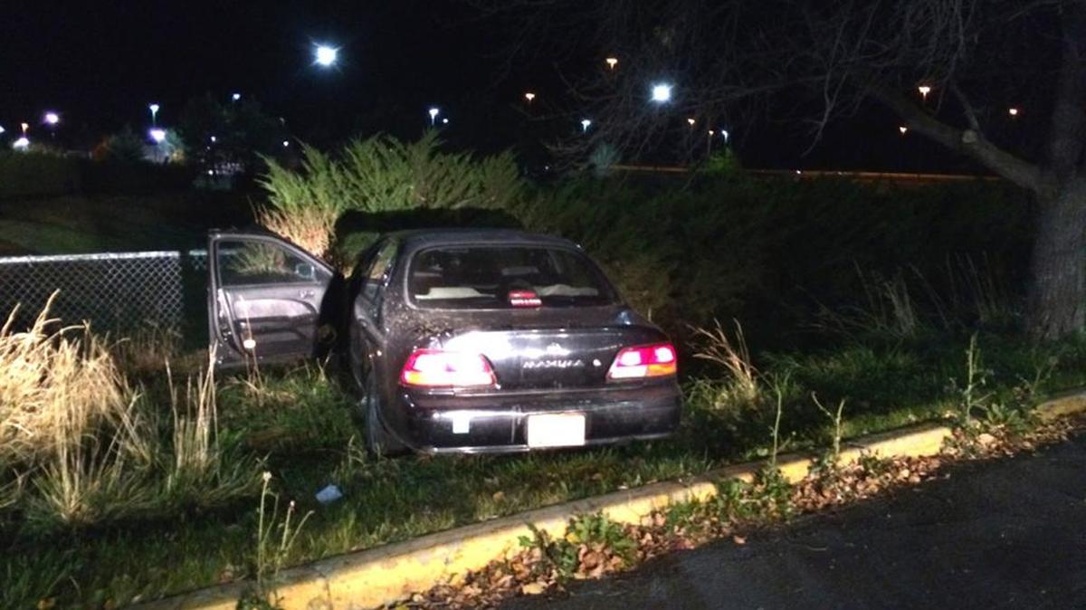 Investigators say this Nissan crashed into a fence near Interstate 84 late Saturday after its driver jumped out and ran across several lanes of the freeway.