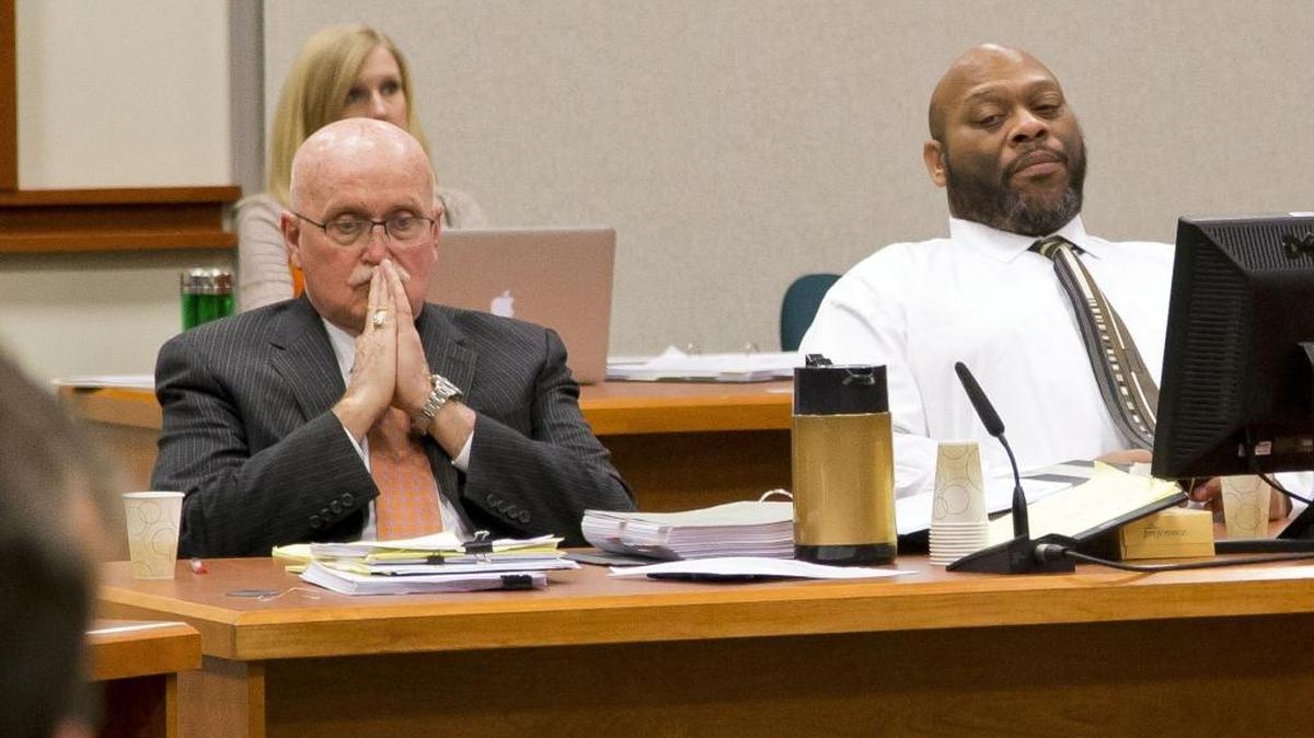 Attorney Jack McMahon, left, waits with his client John C. Douglas for testimony to continue Friday afternoon in the murder trial in Ada County District Court.