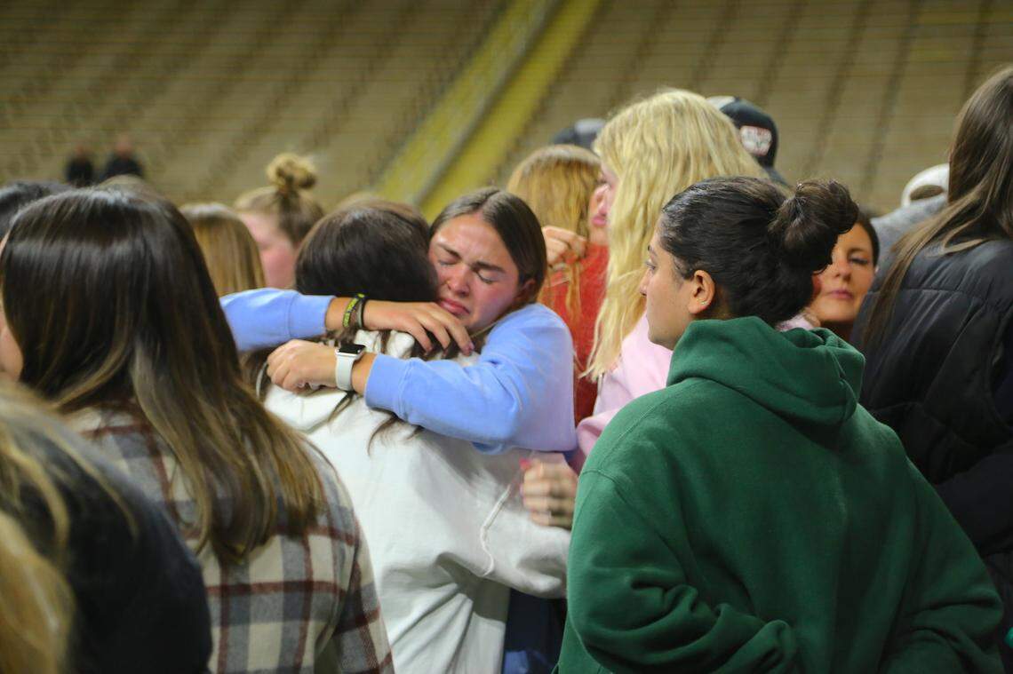 Two attendees embrace at a vigil in Moscow honoring the lives of four slain University of Idaho students.
