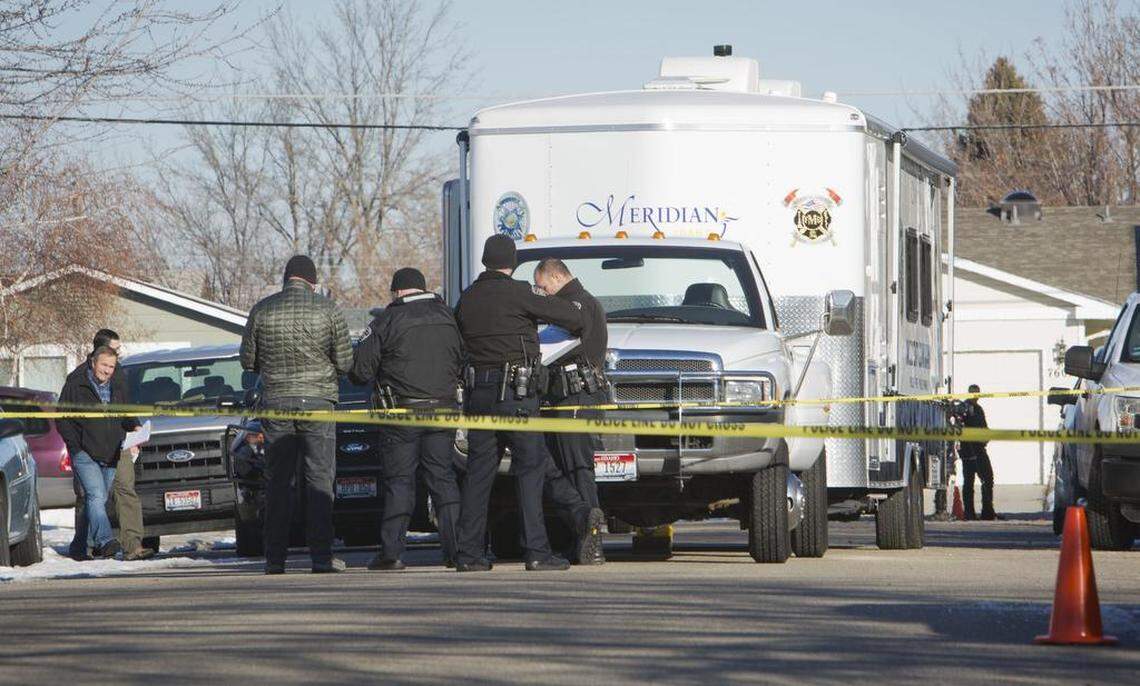Investigators work at South Wild Phlox Way near South Cole Road, the scene of an officer-involved shooting. A man was taken to the hospital after police shot him about 7:30 a.m. New Years Day.