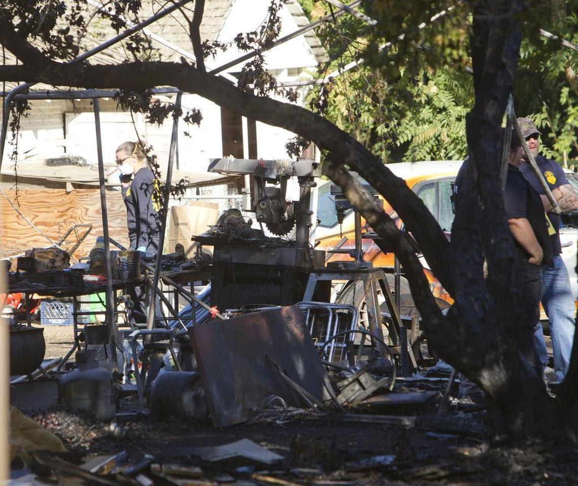 Investigators sift through the remains of a home on the 1500 block of West Amity Road in Meridian that burned during an armed home invasion.