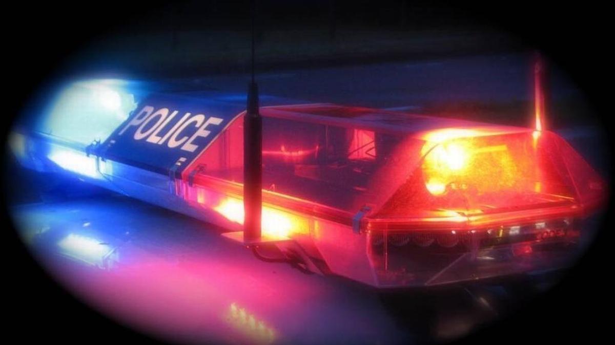 A police car flashes its lights.