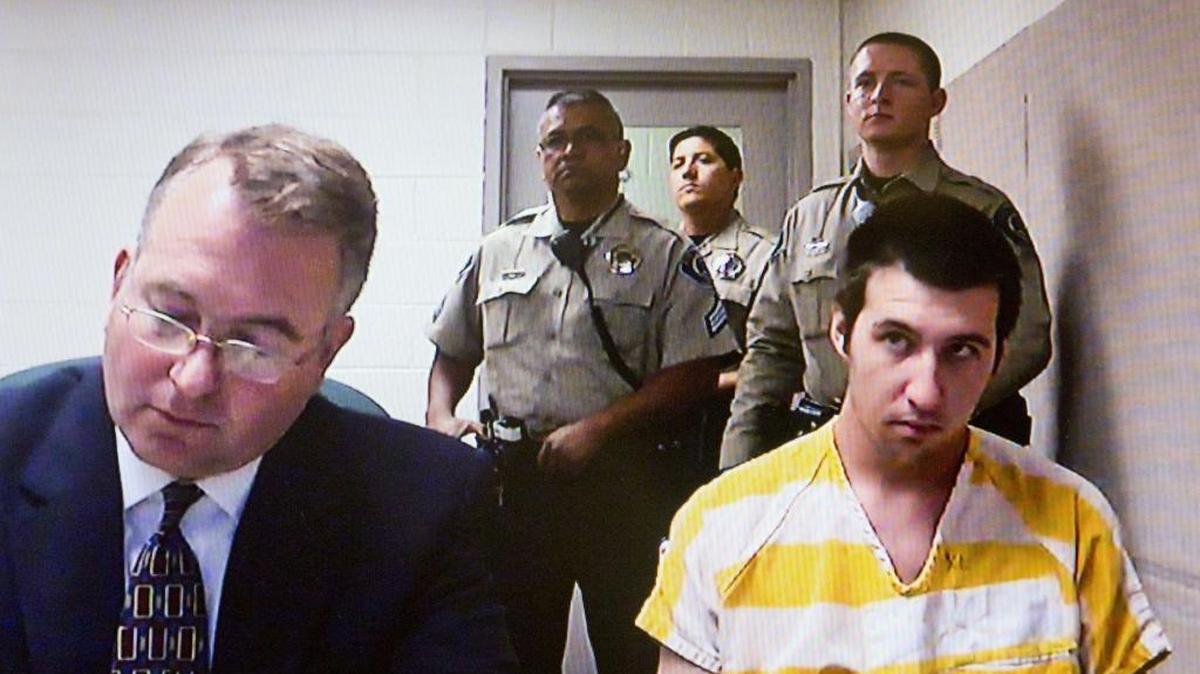 Brandon T. Bahr, 24, with an attorney and several jail deputies during a Sept. 24, 2015 video arraignment.