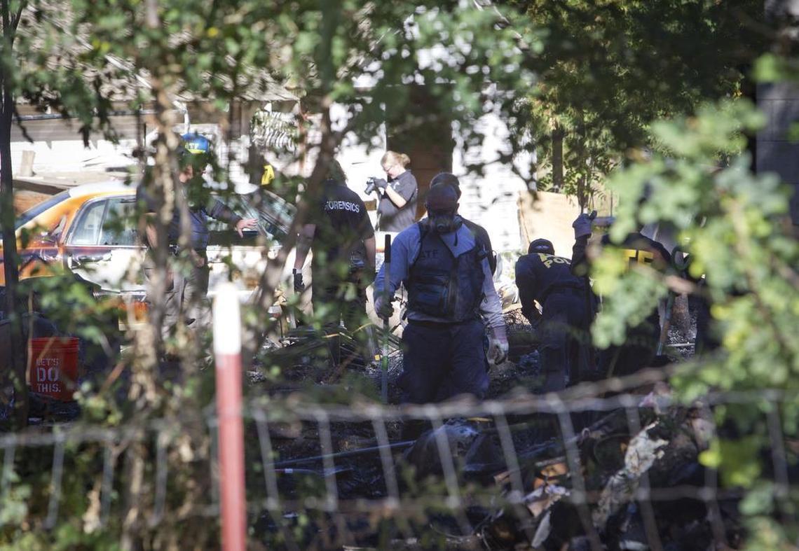 Investigators sift through the remains of a home on the 1500 block of West Amity Road in Meridian that burned during an armed home invasion.