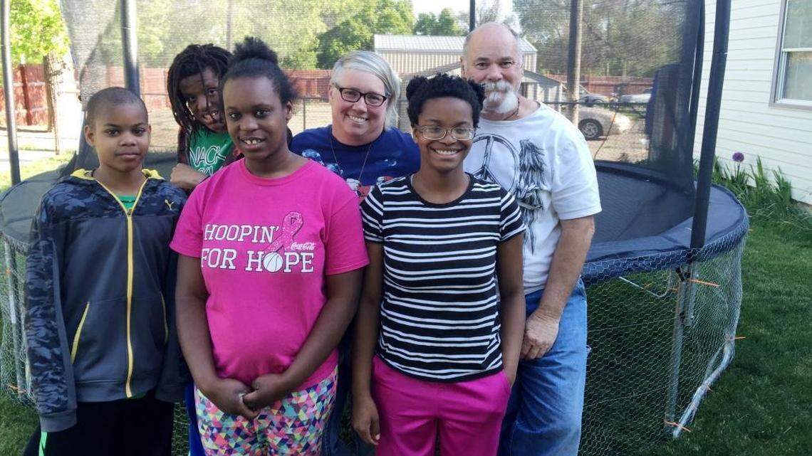 Shelly and Tim McDaniel, back row, right, are seen with some of their adopted children. The couple has 25 children total and the family contains almost the entire black population of Dietrich, Idaho.